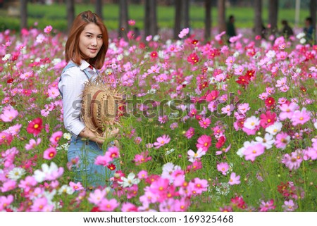 Portrait woman Agriculture in cosmos flower field the garden
