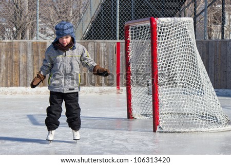 Little girl skating at an outdoor skating rink.