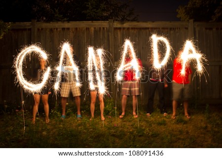 The word Canada in sparklers in time lapse photography as part of Canada Day (July 1) celebration.