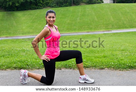 Young woman stretching before a run