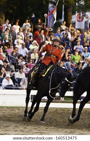 OTTAWA, CANADA - JUNE 27, 2013: The Royal Canadian Mounted Police (RCMP) Musical Ride performs during its Sunset Ceremonies series in Ottawa, Canada on June 27, 2013.