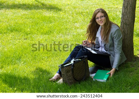 Female college student studies outside on campus