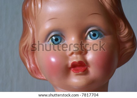 Part of the face of an old doll.