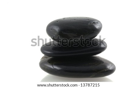 Balancing black stones isolated on a white background.