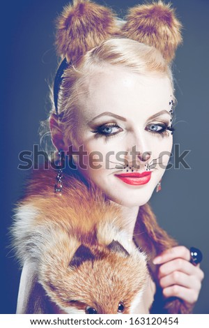 beautiful young blond woman in fancy dress with fox vanilla processing in a vintage style glamor