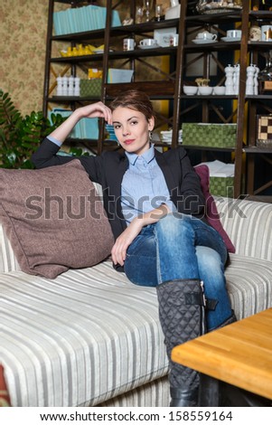 Brunet girl is sitting in interior of Moscow restaurant \