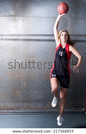Woman in jump throwing the basket ball