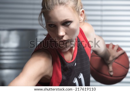 Woman in jump throwing the basket ball