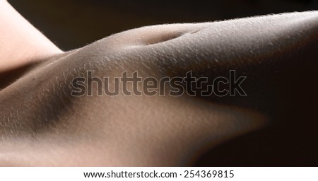 Female body with open stomach on dark background