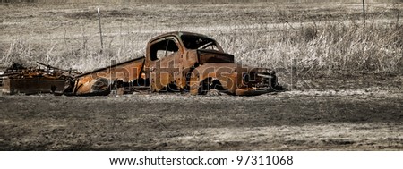 Rustic Truck - An abandoned truck rusts away stuck in the mud in a South Dakota farm yard.