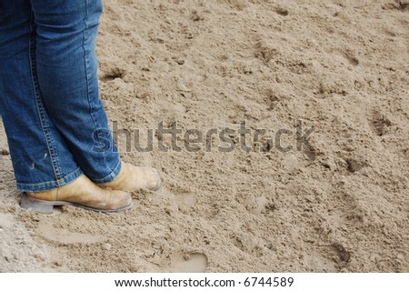 western shoes standing in the sand