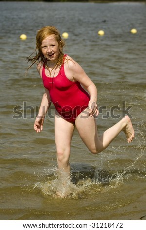little girl is running in the water