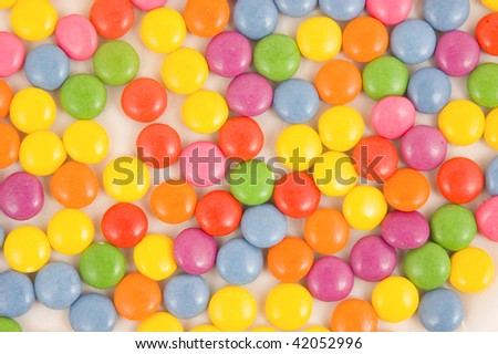 Lots of colorful smarties on white