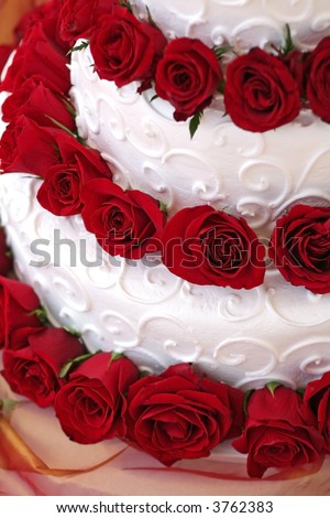 stock photo Beautiful Wedding Cake adorned with red roses