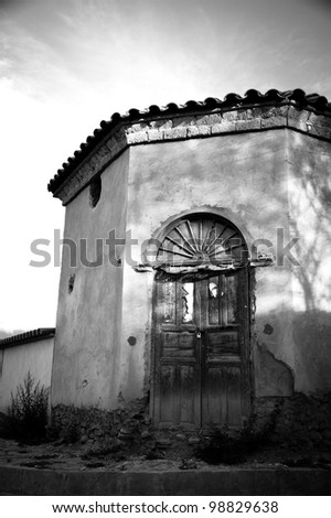 Old black and white door and house in black and white Very old door and house in a Wine Town in Bolivia