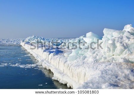 Pierce frozen in ice at sea and blue sky