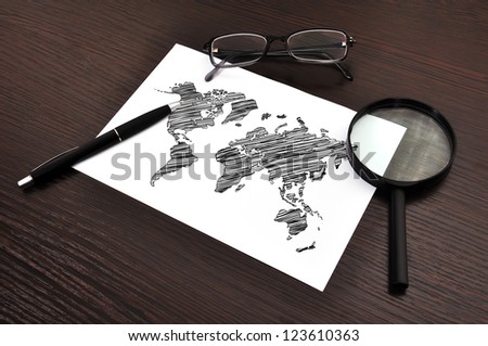 workplace with drawing world map on paper