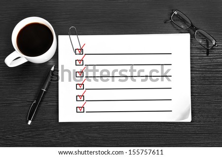 paper with check box on table in office