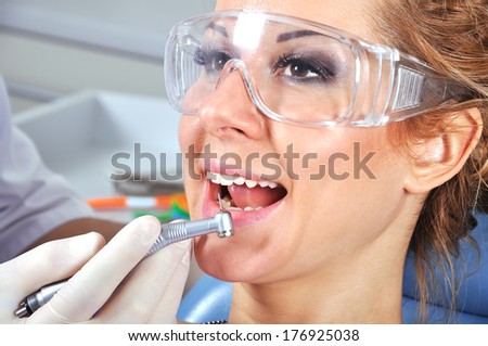 young girl with glasses in dentist office chair
