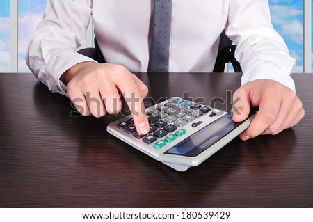 accountant working with calculator in the office