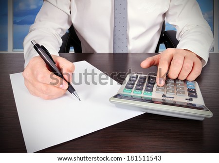 accountant working with calculator and paper in the office