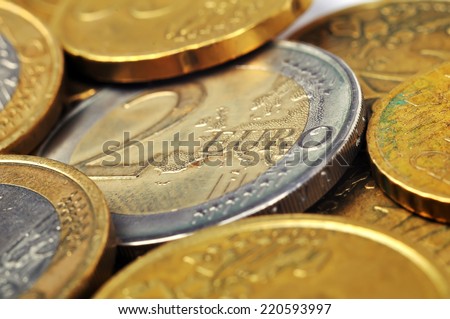 Two Euro coin and many coins, close up