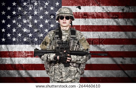 US soldier holding rifle on a american flag background