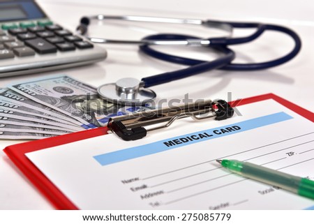 stethoscope, calculator and pen on blank Patient information