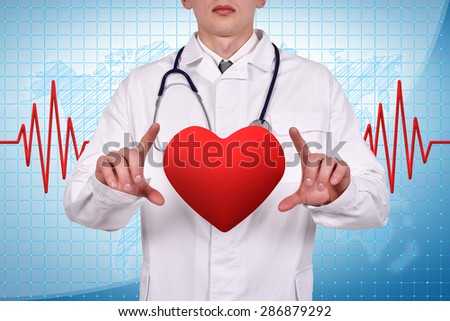doctor holding a heart in hand on blue background