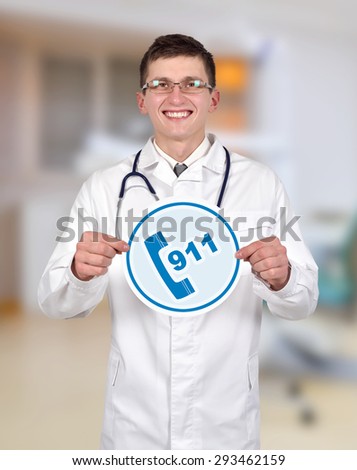 doctor holding 911 symbol on a clinic background