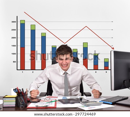 angry businessman and drawing falling chart on wall