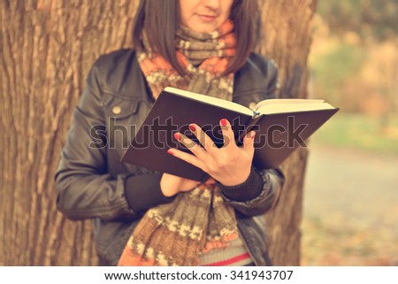 hipster girl reading a diary. Vintage autumn photo