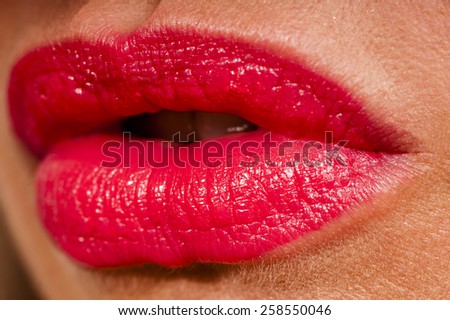 Beautiful woman with red shiny lips close up