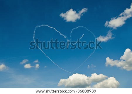 Air Show White Smoke Heart On Blue Sky with White Clouds