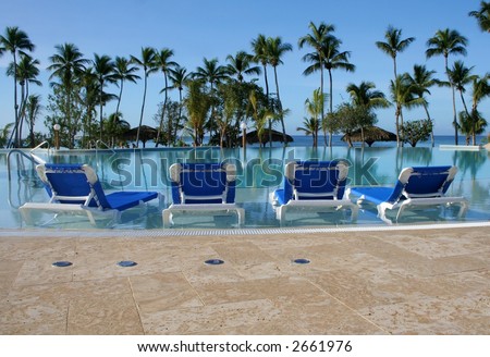 Lounge chairs near a pool on a tropical Island