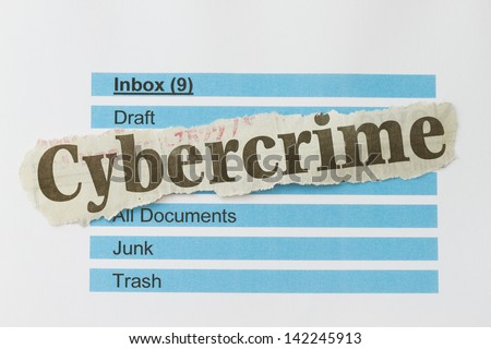 Cybercrime newspaper cutout over an email inbox abstract.