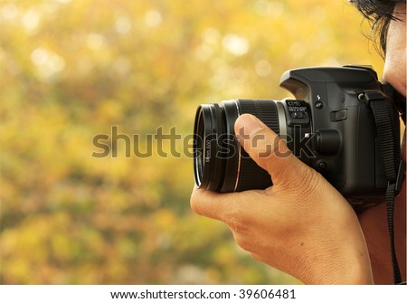 Photographer Taking A Shoot With A Digital Camera And A zoom Lens