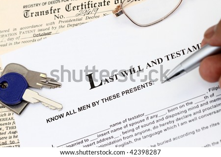 Last Will And Testament document studied with keys and certificate of title.