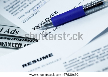 Employment contract ready to sign and resume with ads in the background.