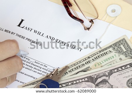 Last Will and Testament with dollars and hand ready for fill-up the form.