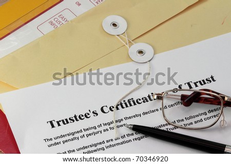 Trust certificate with pen and manila envelop
