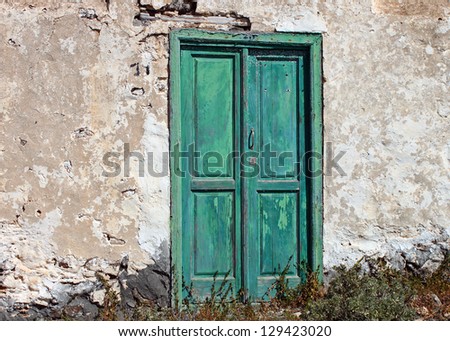 A very old and faded, traditional green door from the Canary Islands.