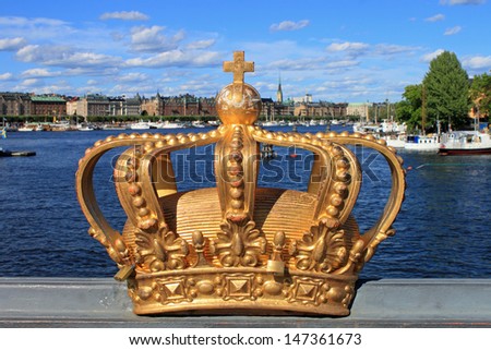 A golden Royal Crown on the Skeppsholmsbron bridge in Stockholm, Sweden.