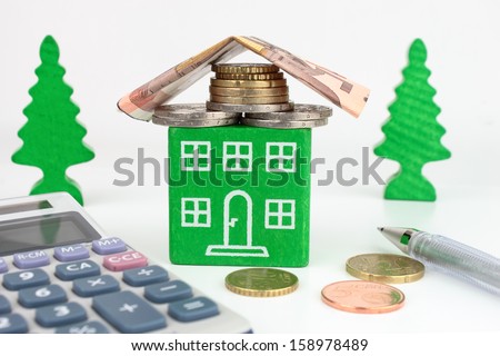 A green home with Euro money for the roof, representing savings to be made with an energy efficient home.
