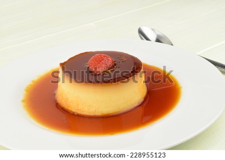 A close-up photograph of a strawberry creme caramel.