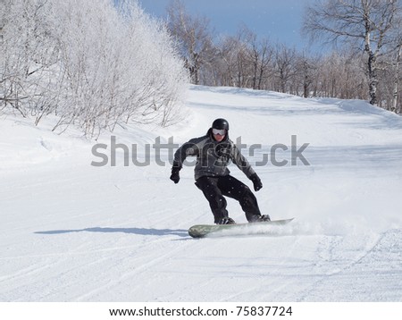 Snowboarder on the mountain slope. Russia, the Ural Mountains