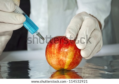 Red apple in genetic engineering laboratory, gmo food concept