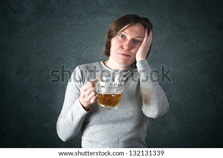 Portrait of an adult woman drinking beer, sad face - depression concept.