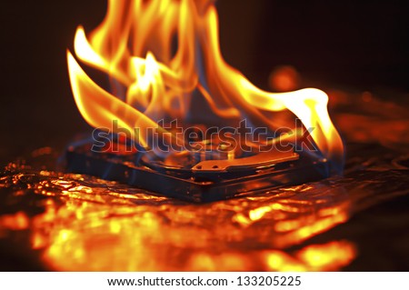 Hard disk failure. Computer hard disk on fire, burning in flames. Computer crash.