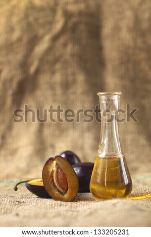 Plum brandy with fresh and tasty plum fruit on a table cloth.